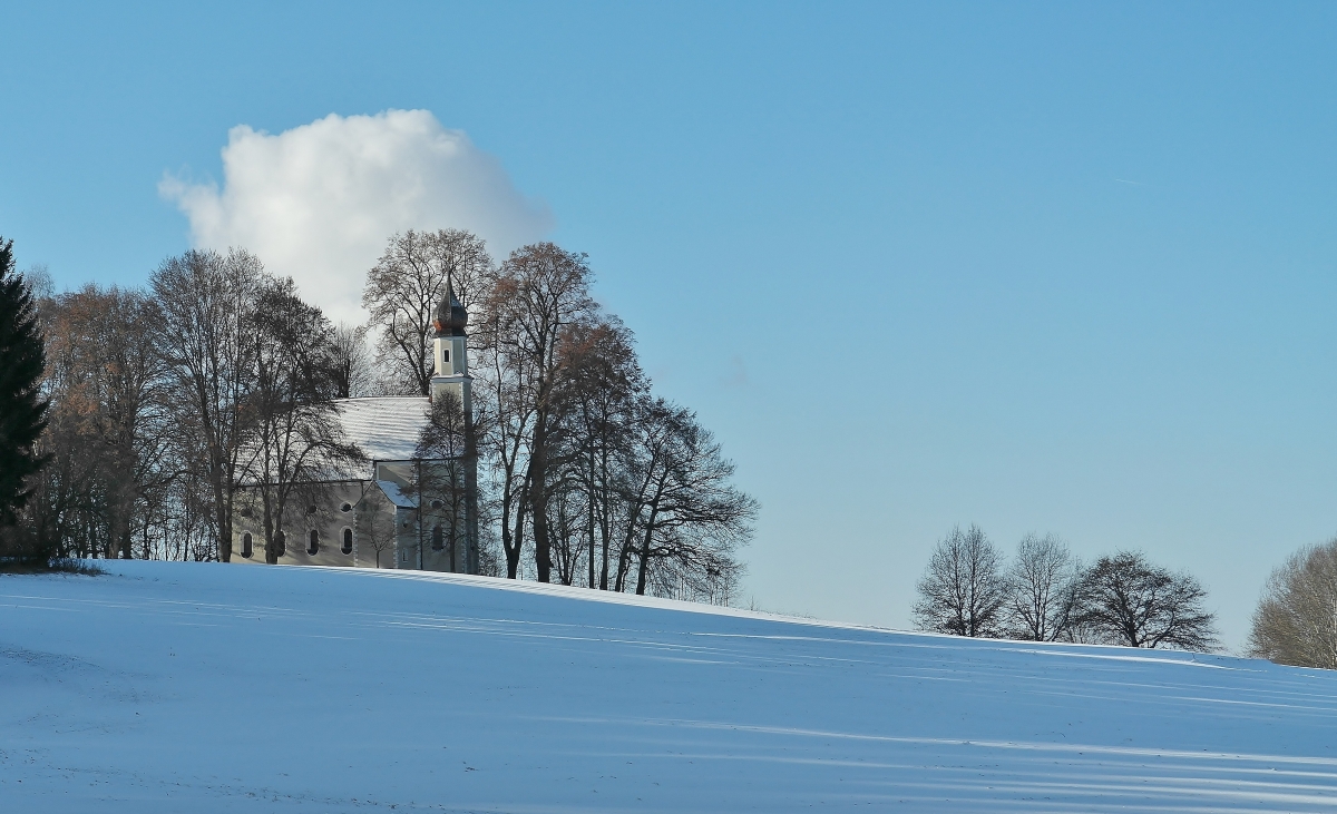 Small church winter landscape blue sky