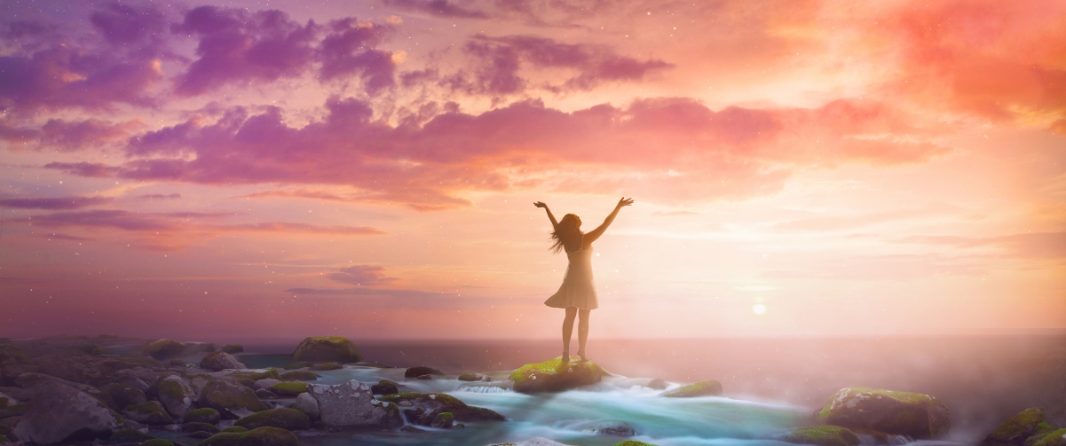 Woman raised her arms by the seaside sunrise