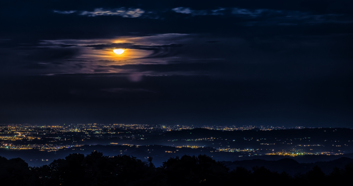 Bright night city moon clouds