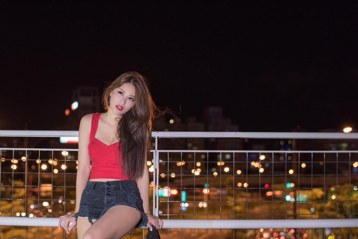 Long hair beauty in city guardrail at night