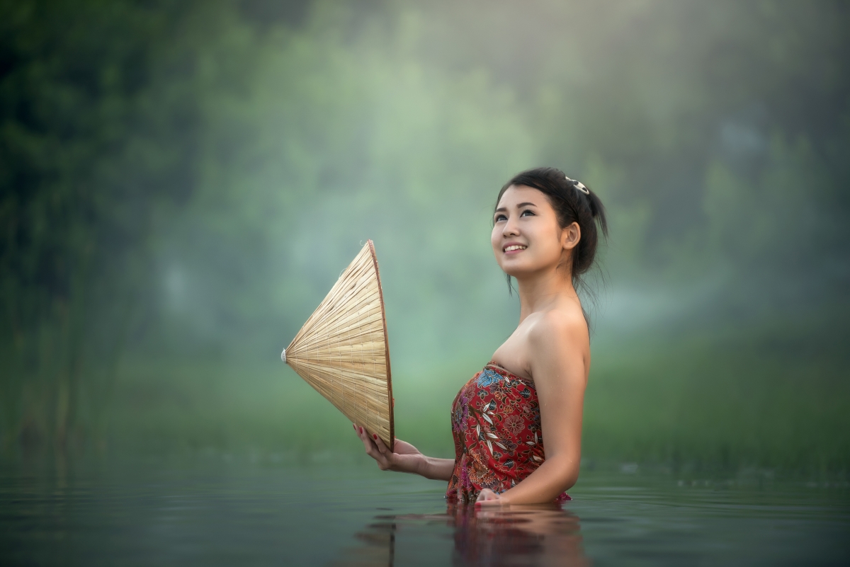 Young woman in water bathing cape