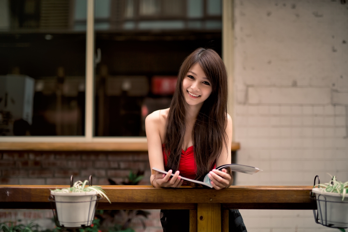 Beautiful smiling woman with book long hair 4k wall