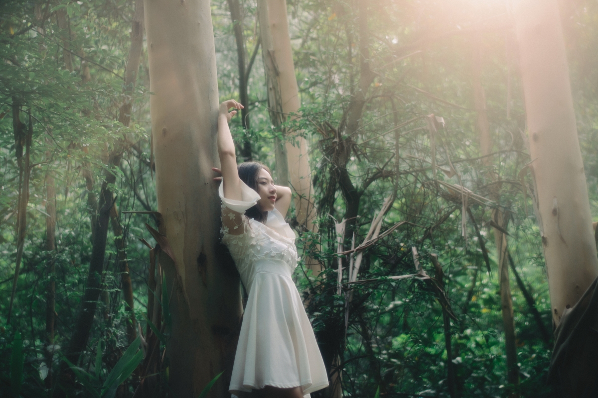 Beautiful photo of beautiful woman in white skirt in forest