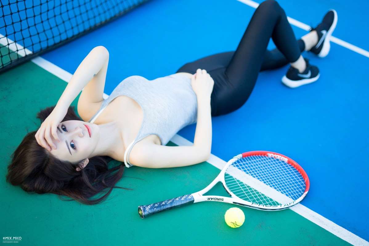 Sexy cutie lying flat on the court