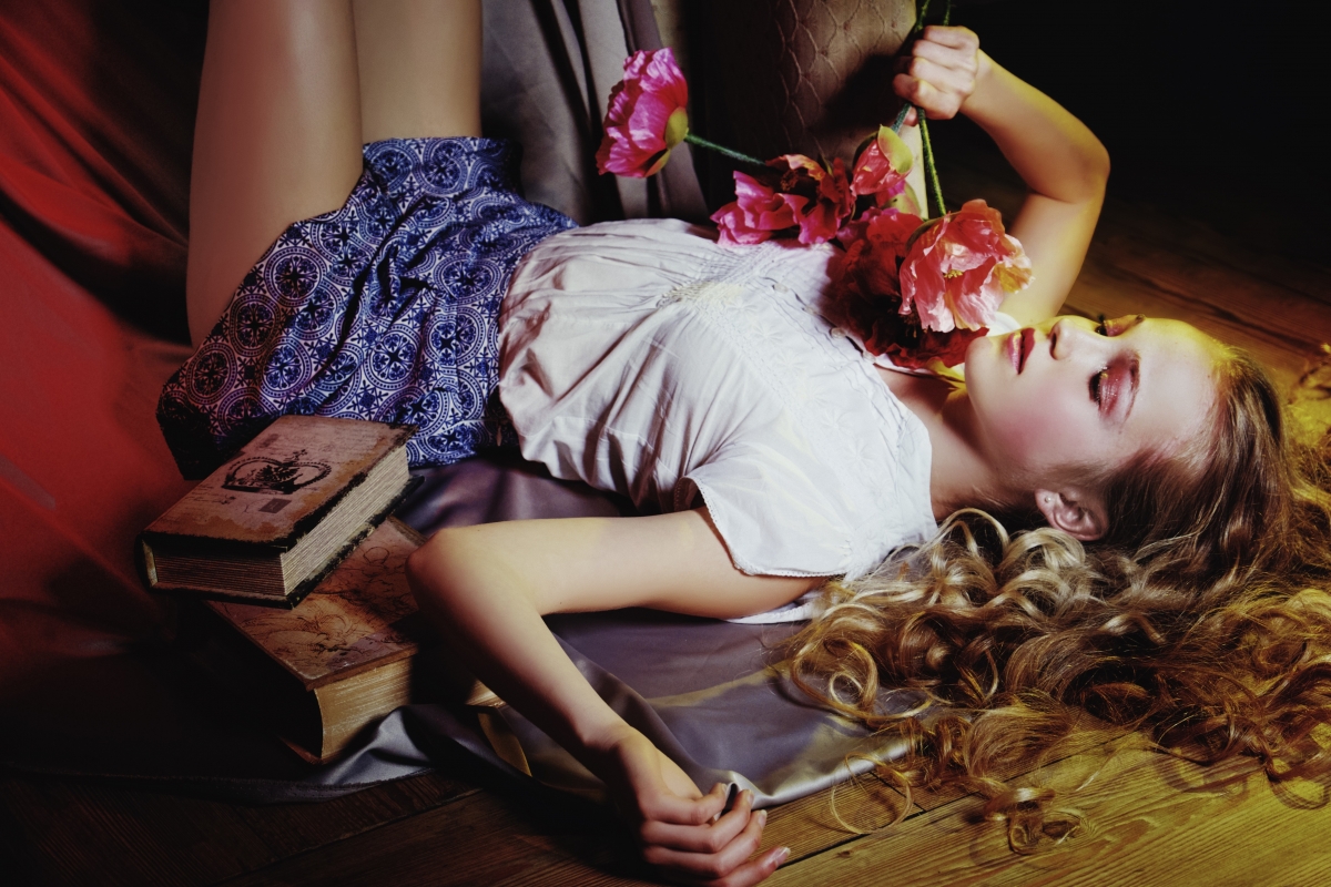 Girl with curly hair, eyes closed, mood, books