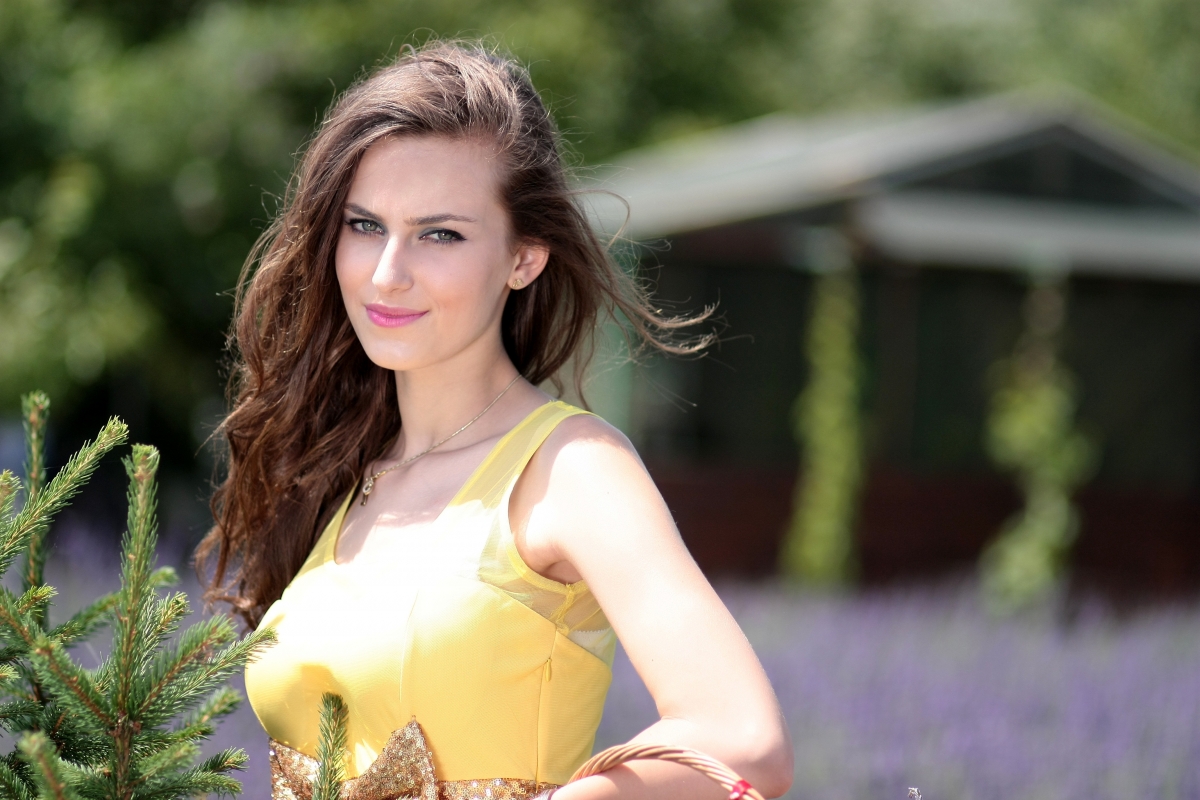 Girl in yellow dress with lavender flowers