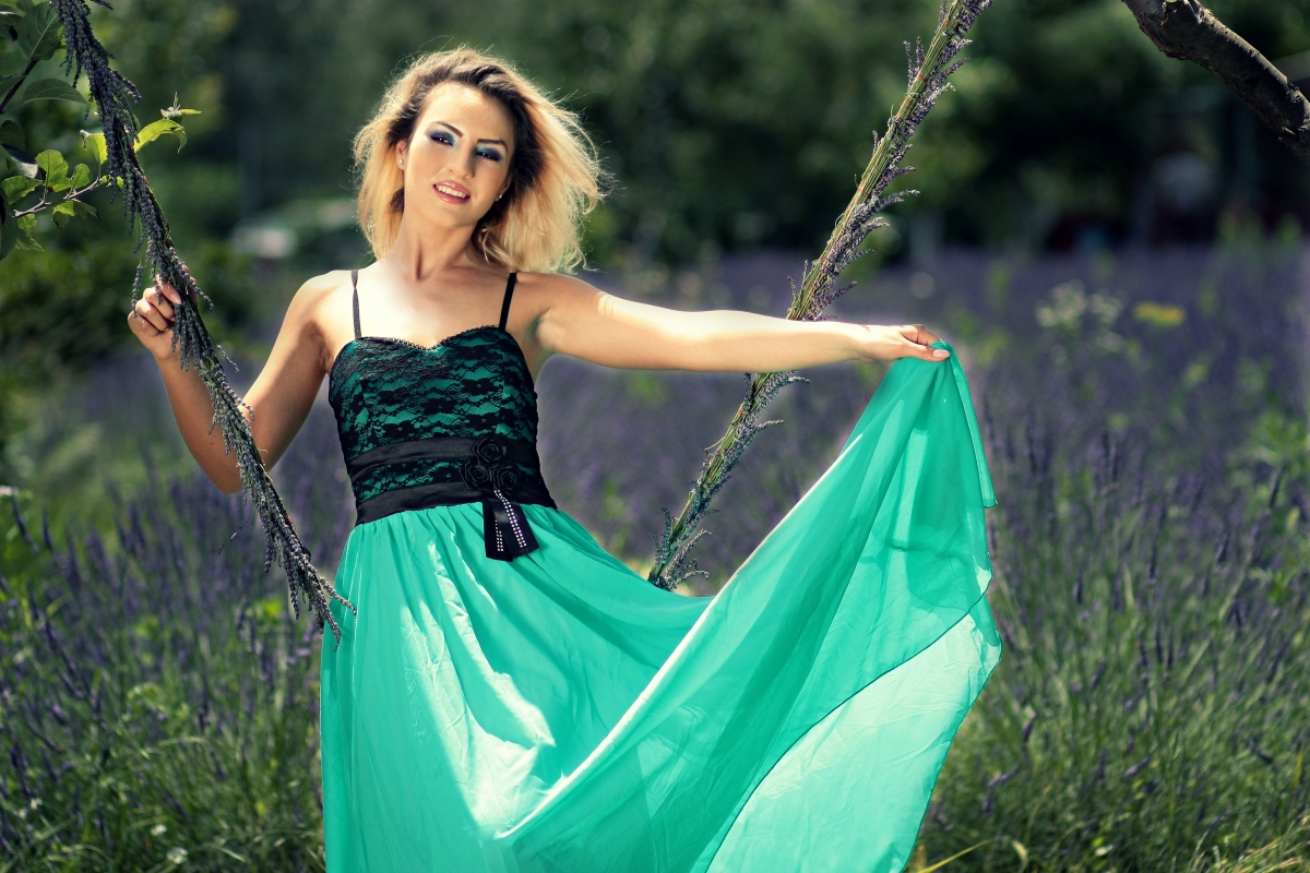 Girl swinging on lavender swing