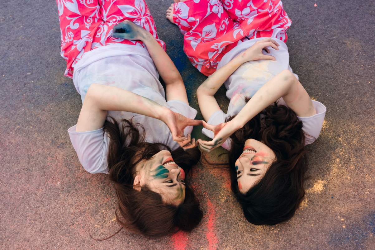 Colored face friendship lying down and smiling