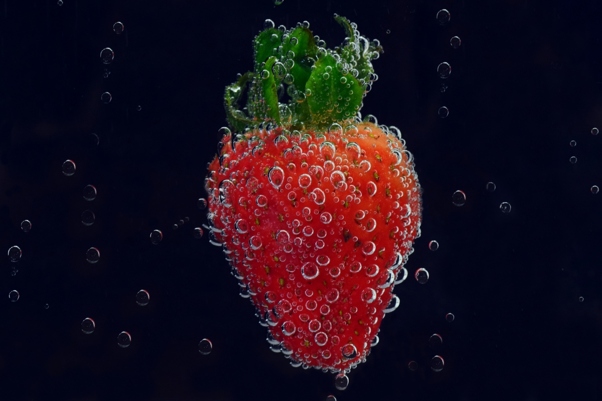Strawberry falling into water 6k picture