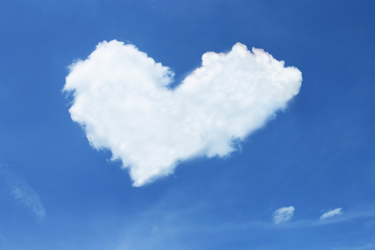Creative photo of heart-shaped white clouds under the blue sky